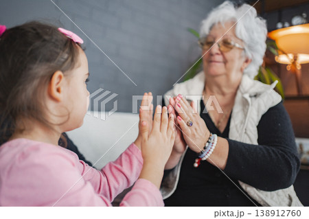 Grandma and granddaughter share joyful play Grandma and granddaughter share joyful play 138912760