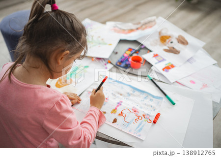 Creative child engaged in colorful art time at home Creative child engaged in colorful art time at home 138912765