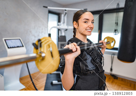 Woman strength training with new equipment Woman strength training with new equipment 138912803