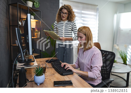 Two Women Working on a Computer in an Office Two Women Working on a Computer in an Office 138912831