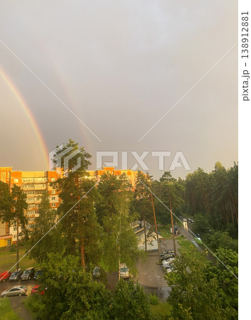 Double rainbow over residential buildings and forest after rain, cityscape with impressive sky and sunlight Double rainbow over residential buildings and forest after rain, cityscape with impressive sky and sunlight 138912881