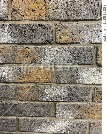 Different shades on a brick wall in a city building during daytime hours 138912888