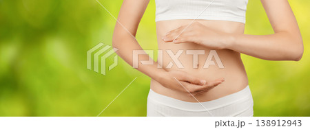 Woman holding stomach on green background, digestive health and gut care concept 138912943