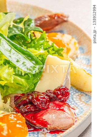 Closeup of gourmet appetizer plate with salad, soft cheese, duck breast and berry sauce for restaurant menu advertising Closeup of gourmet appetizer plate with salad, soft cheese, duck breast and berry sauce for restaurant menu advertising 138912994