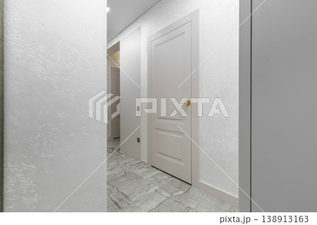 Classic White Door with Gold Handle in Bright Minimalist Hallway 138913163