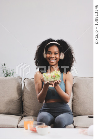Young nutritionist showing bell peppers during an online video call consulting about healthy eating, sitting at home at a table with vegetables, laptop and measuring tape Young nutritionist showing bell peppers during an online video call consulting about healthy eating, sitting at home at a table with vegetables, laptop and measuring tape 138913346