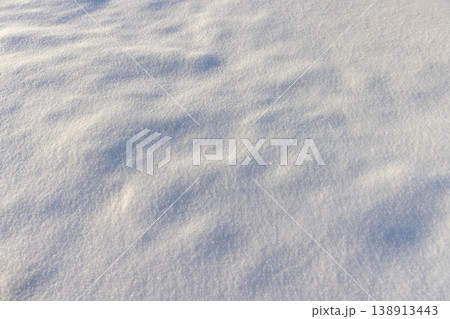 large deep fresh snowdrifts of white color in the field during the winter season, large soft snowdrifts after large snowfalls , snow structure in sunlight large deep fresh snowdrifts of white color in the field during the winter season, large soft snowdrifts after large snowfalls , snow structure in sunlight 138913443