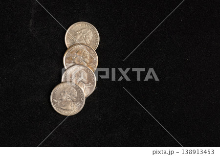 worn quarter dollar coins on black velvet fabric, real currency worn quarter dollar coins on black velvet fabric, real currency 138913453