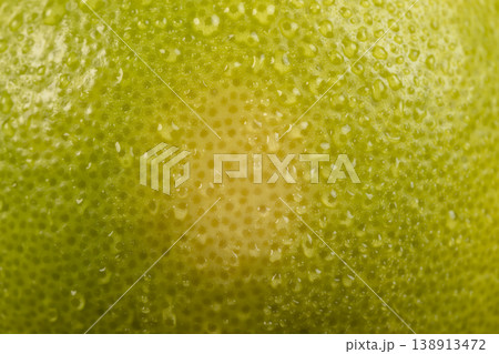a wet yellow-green grapefruit on the table, citrus grandis a wet yellow-green grapefruit on the table, citrus grandis 138913472