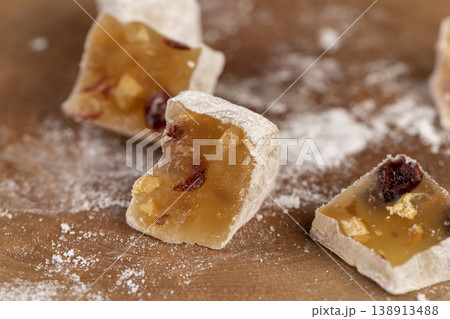 soft Turkish delight sprinkled with powdered white sugar, diced sweet white soft Turkish delight slices with nuts and dried fruits, cut into pieces 138913488