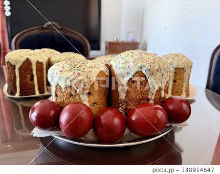 Easter cakes and red eggs on table. A traditional homemade Easter pastry. 138914647