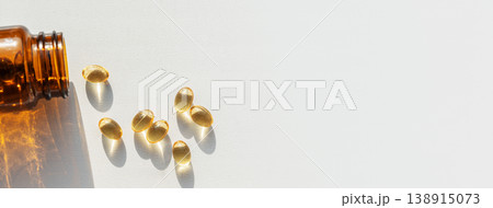 Glass dark bottle spilling vitamin pills, symbolizing daily health and wellness supplements, enhancing personal healthcare. Pills spilling from bottle for health treatments Glass dark bottle spilling vitamin pills, symbolizing daily health and wellness supplements, enhancing personal healthcare. Pills spilling from bottle for health treatments 138915073