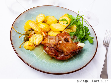 Confit duck with boiled potato and arugula 138916057