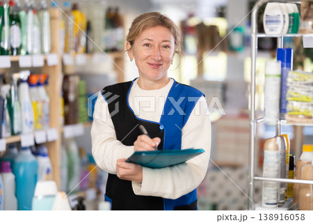 Adult woman seller conducting inventory in store Adult woman seller conducting inventory in store 138916058