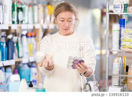 Female shopper chooses scented candles in supermarket for romantic evening Female shopper chooses scented candles in supermarket for romantic evening 138916110