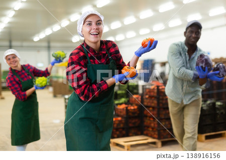 Vegetable factory workers performing funny dance with vegetables Vegetable factory workers performing funny dance with vegetables 138916156