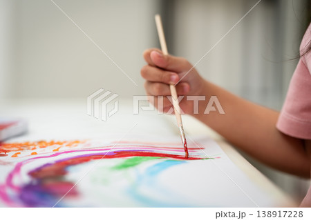 close up of preschool child girl painting on paper with watercolor in pan 138917228