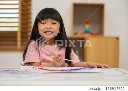 happy preschool child girl painting with watercolor on paper 138917232
