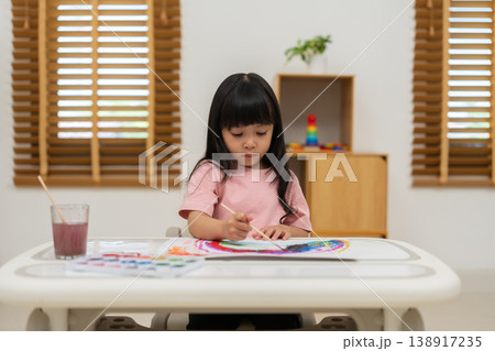 preschool child girl painting on paper with watercolor in pan 138917235