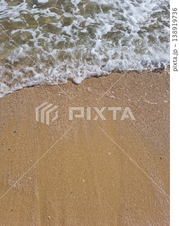 It is a sandy beach with waves rolling in. It is a sandy beach with waves rolling in. 138919736