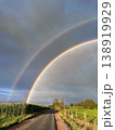 A Stunning and Beautiful Double Rainbow Over a Picturesque Scenic Road Surrounded by Nature 138919929