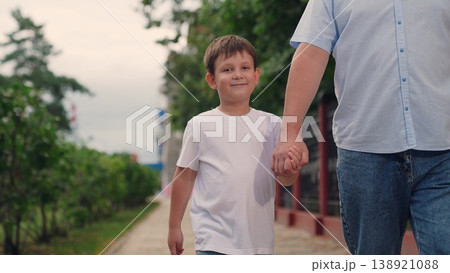 happy family, father son walking together in park, parent hold child hand in park, man with child boy outdoors walking together, boy kid child play with parent looking, play outdoors, fun walk child happy family, father son walking together in park, parent hold child hand in park, man with child boy outdoors walking together, boy kid child play with parent looking, play outdoors, fun walk child 138921088