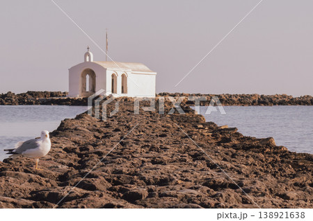 Georgioupolis Agios Nikolaos coastal chapel and solitary seagull 138921638
