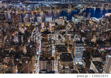 : Aerial night view of Manhattan cityscape with illuminated streets, skyscrapers and East River waterfront in New York City USA : Aerial night view of Manhattan cityscape with illuminated streets, skyscrapers and East River waterfront in New York City USA 138921672