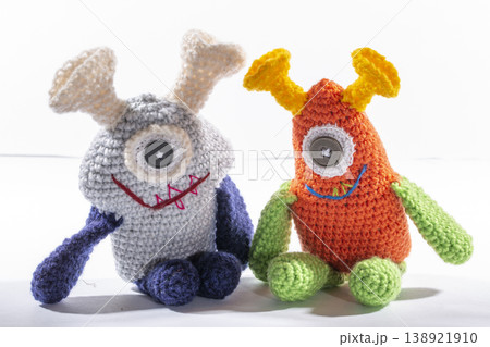 Knitted wool aliens on a white background Knitted wool aliens on a white background 138921910