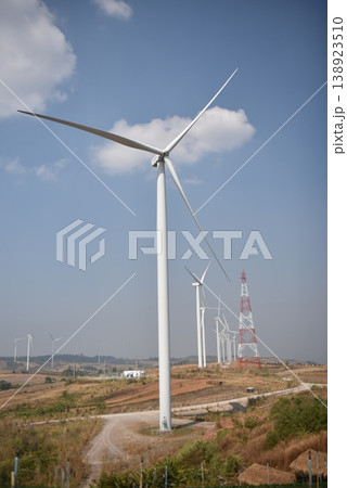 Sustainable Wind Farm with White Turbines and Power Infrastructure on Rural Hills Sustainable Wind Farm with White Turbines and Power Infrastructure on Rural Hills 138923510