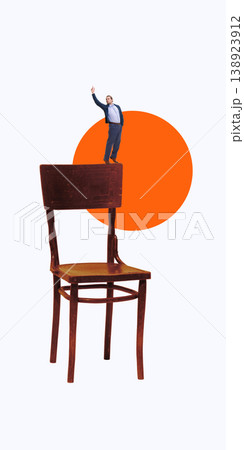Miniature businessman standing on chair pointing upward with bold orange circle background. 138923912