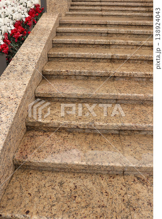 concrete stairs covered with red flowers 138924043