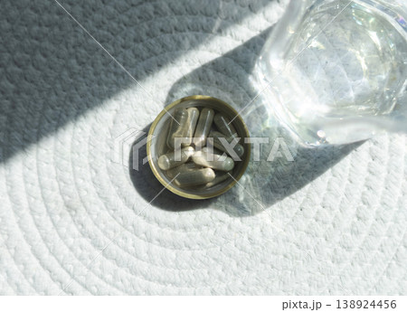 Close-up of iron supplement capsules in a lid for iron deficiency anemia treatment. Health care, wellness, and dietary supplements for daily vitamins and minerals intake. Close-up of iron supplement capsules in a lid for iron deficiency anemia treatment. Health care, wellness, and dietary supplements for daily vitamins and minerals intake. 138924456