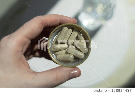 Close-up of iron supplement capsules in a lid for iron deficiency anemia treatment. Health care, wellness, and dietary supplements for daily vitamins and minerals intake. Close-up of iron supplement capsules in a lid for iron deficiency anemia treatment. Health care, wellness, and dietary supplements for daily vitamins and minerals intake. 138924457