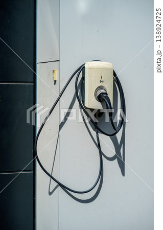 Electric vehicle charging wall box with cable connected,EV infrastructure, clean energy solution, modern technology for sustainable transport mobility Electric vehicle charging wall box with cable connected,EV infrastructure, clean energy solution, modern technology for sustainable transport mobility 138924725