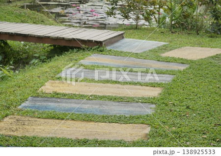 Walkway with a bridge over a pond Walkway with a bridge over a pond 138925533