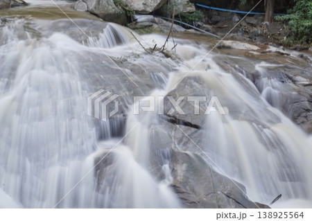 Waterfall with a blue rope hanging from it Waterfall with a blue rope hanging from it 138925564