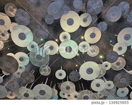 Cluster of white and silver spheres hang from the ceiling 138925603