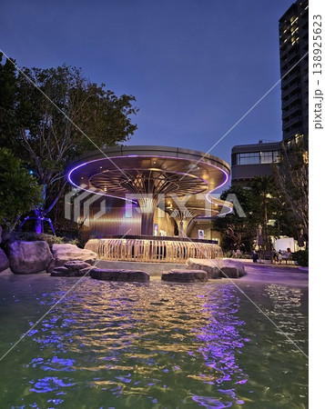 Large fountain with a tree in the middle of it Large fountain with a tree in the middle of it 138925623