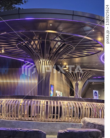 Large, curved structure with purple lights shining on it Large, curved structure with purple lights shining on it 138925624