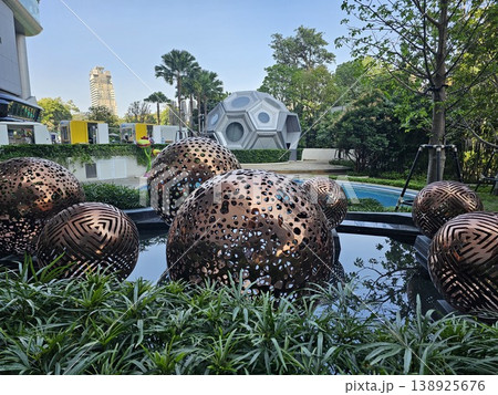 Large collection of metal spheres are arranged in a pond Large collection of metal spheres are arranged in a pond 138925676