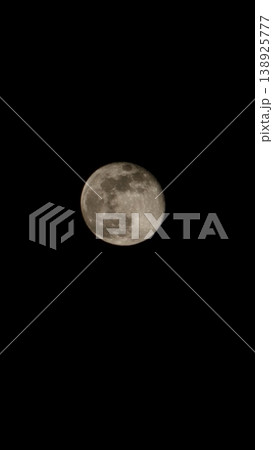 Large, round moon is in the center of a black sky 138925777