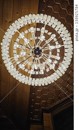 Large chandelier with many white crystals hanging from it Large chandelier with many white crystals hanging from it 138925784