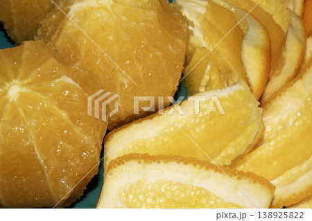 Close up of sliced peeled oranges on a chopping board prepped for using in a salad Close up of sliced peeled oranges on a chopping board prepped for using in a salad 138925822