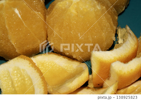 Close up of sliced peeled oranges on a chopping board prepped for using in a salad 138925823