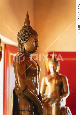 Serene Buddha Statue in Warm Light Displaying Tranquility and Spirituality in an Indoor Environment with Rich Textures and Colors Serene Buddha Statue in Warm Light Displaying Tranquility and Spirituality in an Indoor Environment with Rich Textures and Colors 138928675