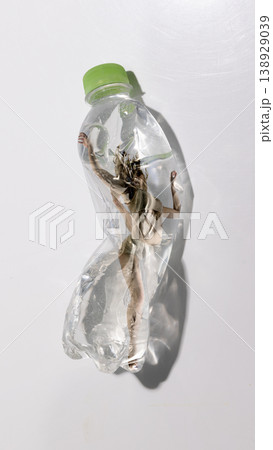 Woman distorted inside plastic bottle showing loss of identity and emotional fragmentation. 138929039