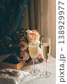 Two glasses of champaign for a broom and a bride. Wedding decor. Glasses with champaign. Bible and pillow with wedding rings. Romantic decor. Wedding anniversary. Love concept. Wedding celebration.  138929977
