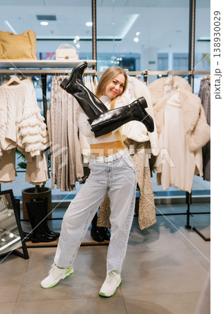 Shopping Woman Holding Boots Like X Shape in Mall 138930029