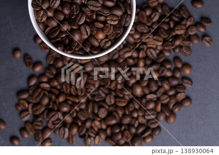 Roasted coffee beans and cup of coffee on granite background Roasted coffee beans and cup of coffee on granite background 138930064